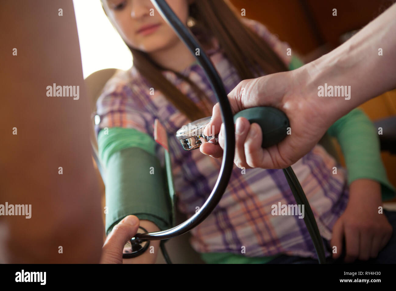 Doctor measuring a child's blood pressure Stock Photo