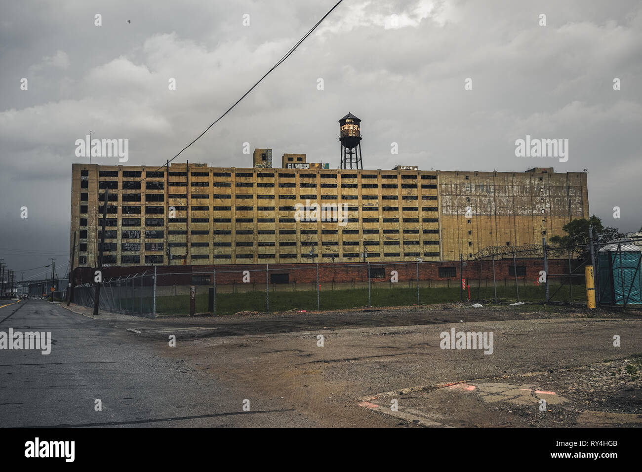 Detroit, Michigan, May 18, 2018: View towards abandoned Detroit Automotive Factory with water tower and Chimney. Stock Photo