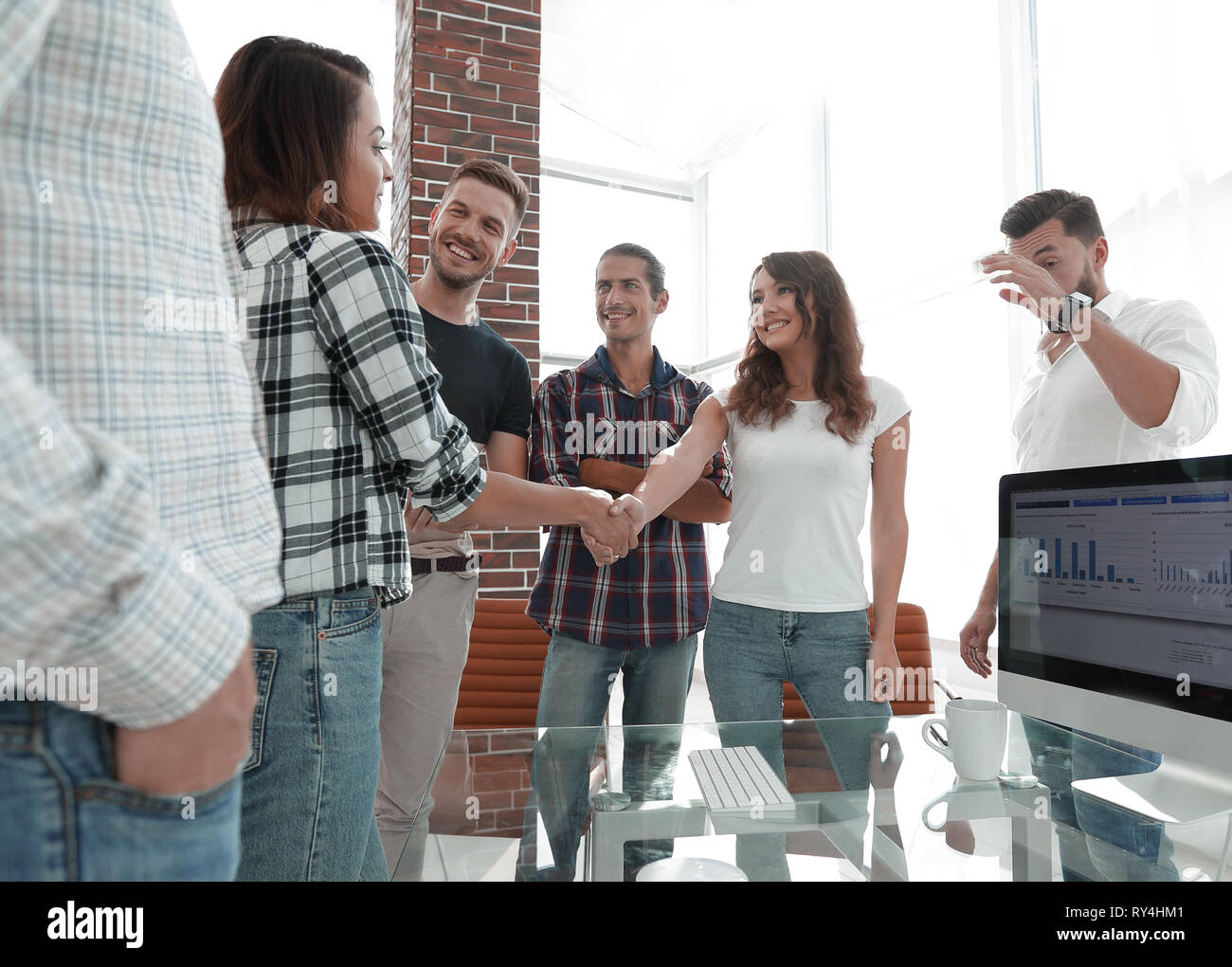 handshake of young designers and client Stock Photo - Alamy