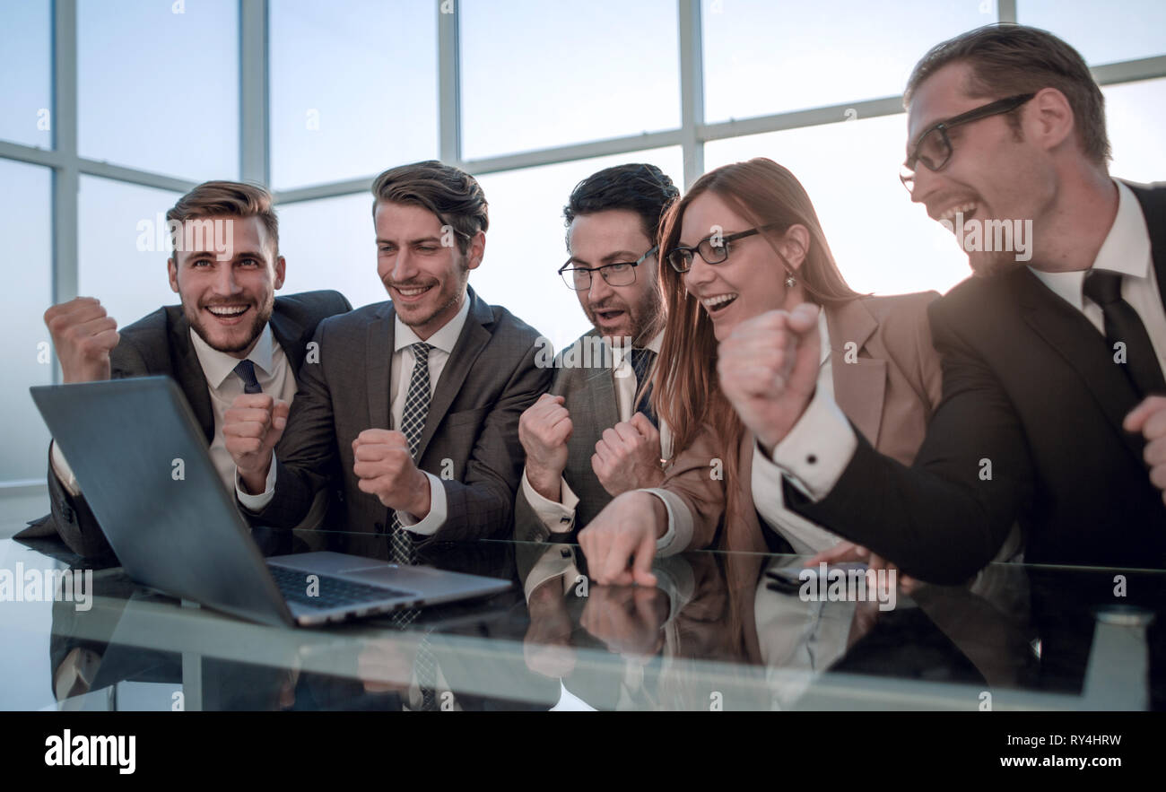 Happy businessman cheering desk hi-res stock photography and images - Alamy