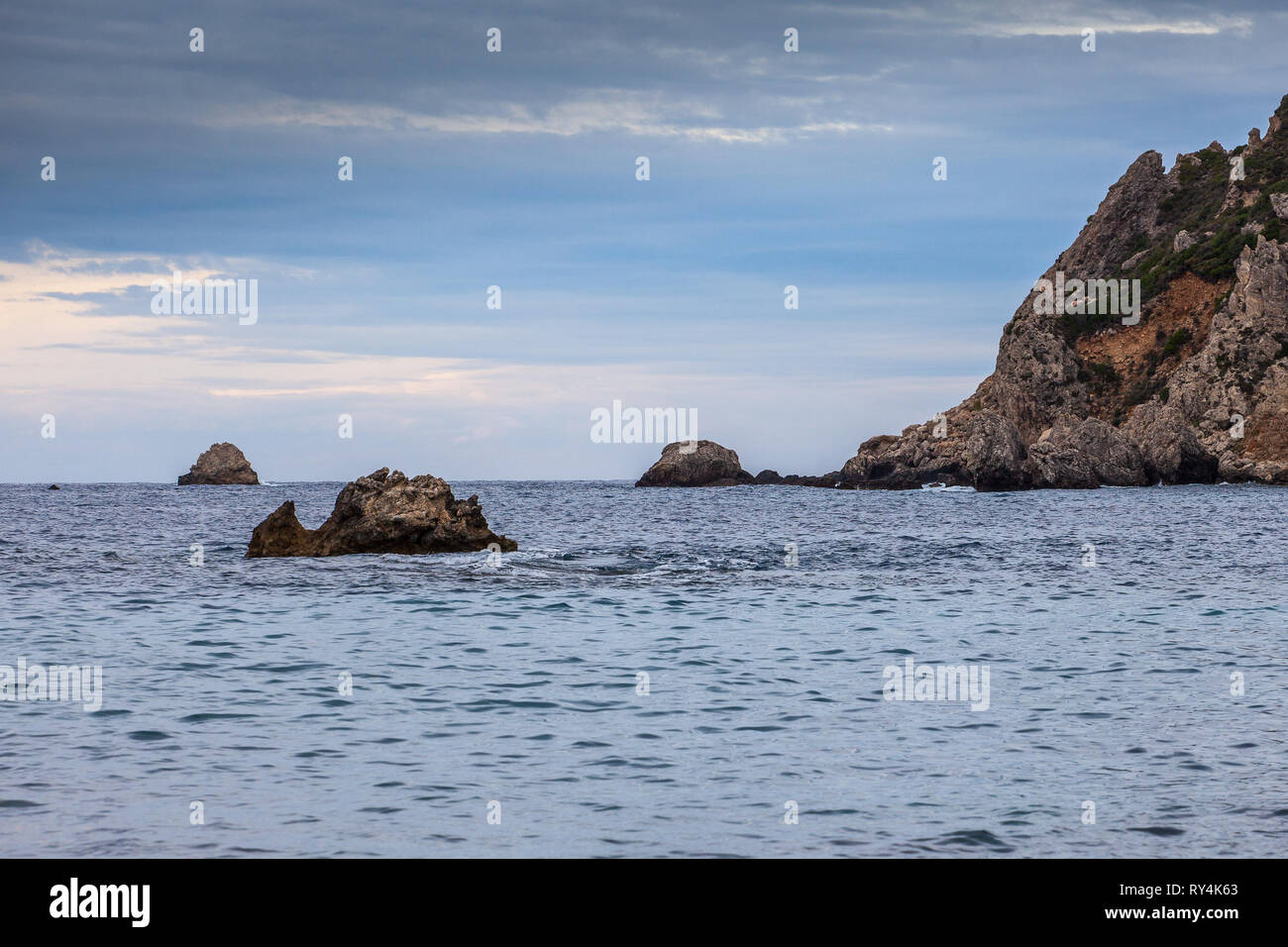 Paleokastritsa bay cliffs and rocks on a cloudy day, Corfu Island, Greece Stock Photo