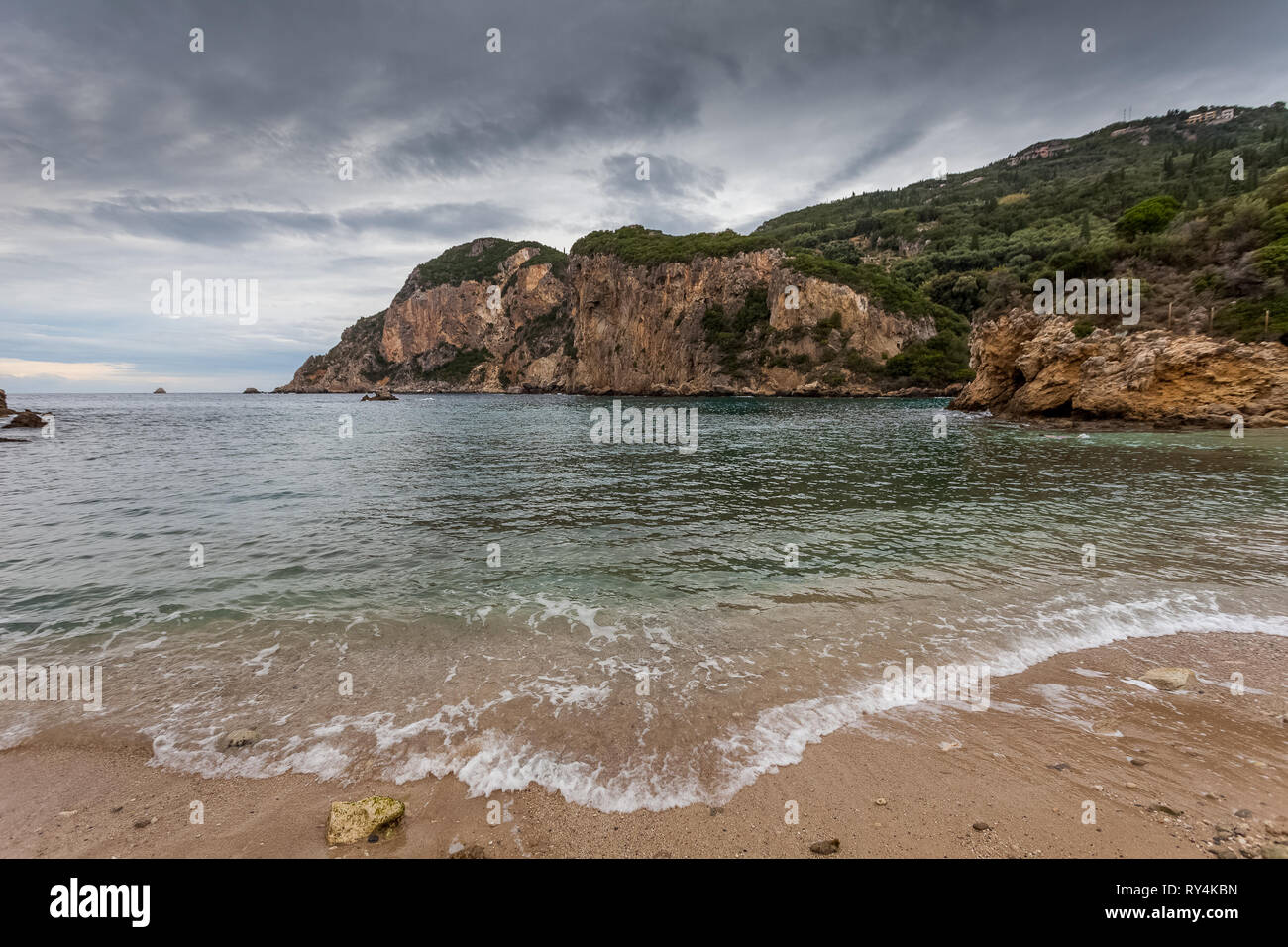 Paleokastritsa bay cliffs and beach on a rainy day, Corfu Island, Greece Stock Photo