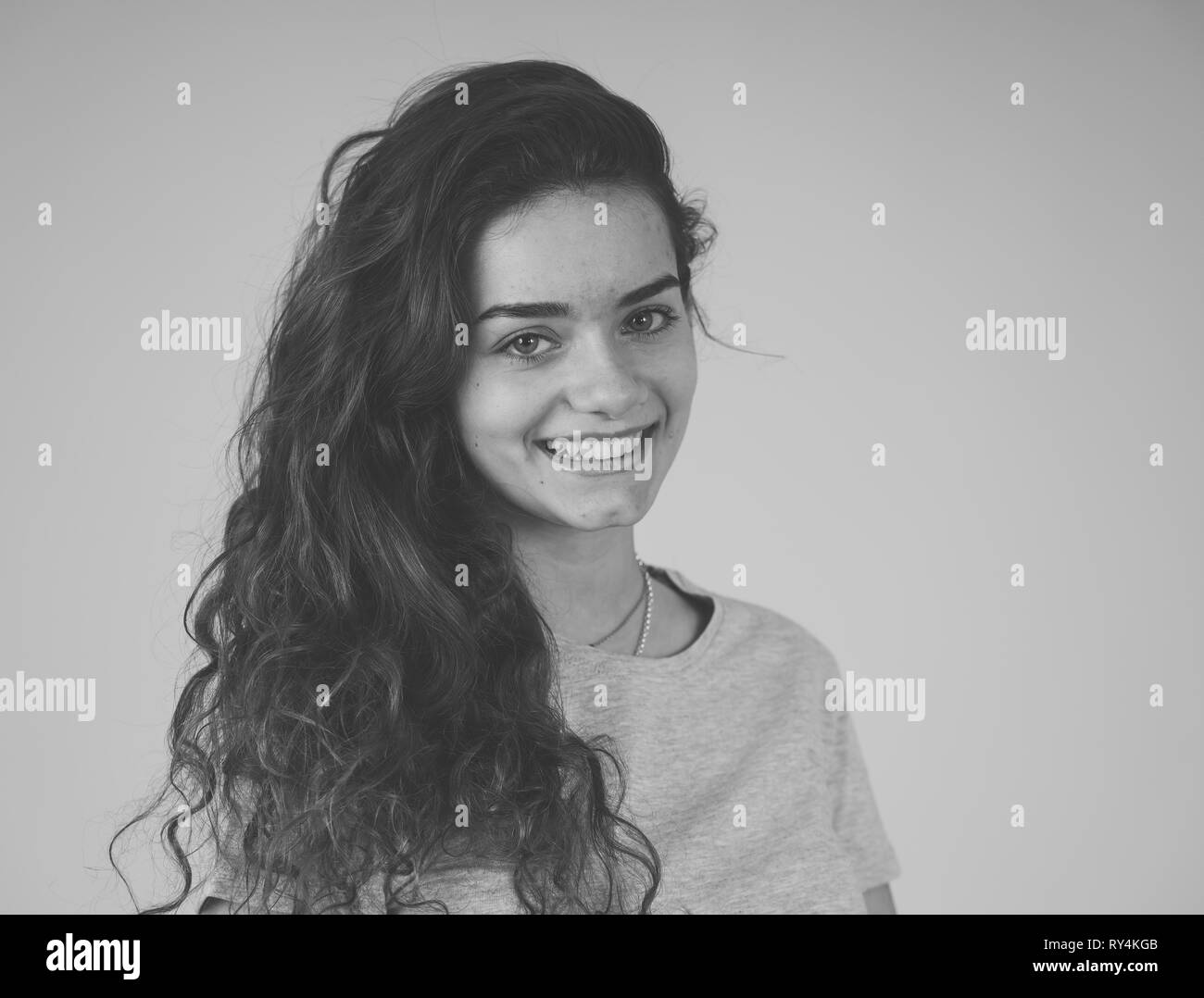 Close up black and white portrait of beautiful young teenager woman with cute smile and stylish look and poses. Happiness, beauty and People and fashi Stock Photo