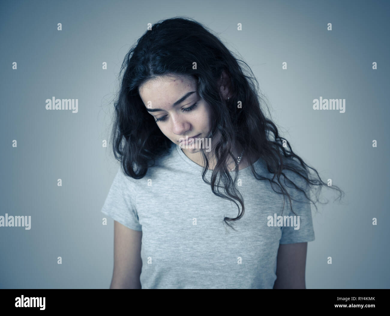 Portrait of sad young teen girl feeling unhappy, miserable and