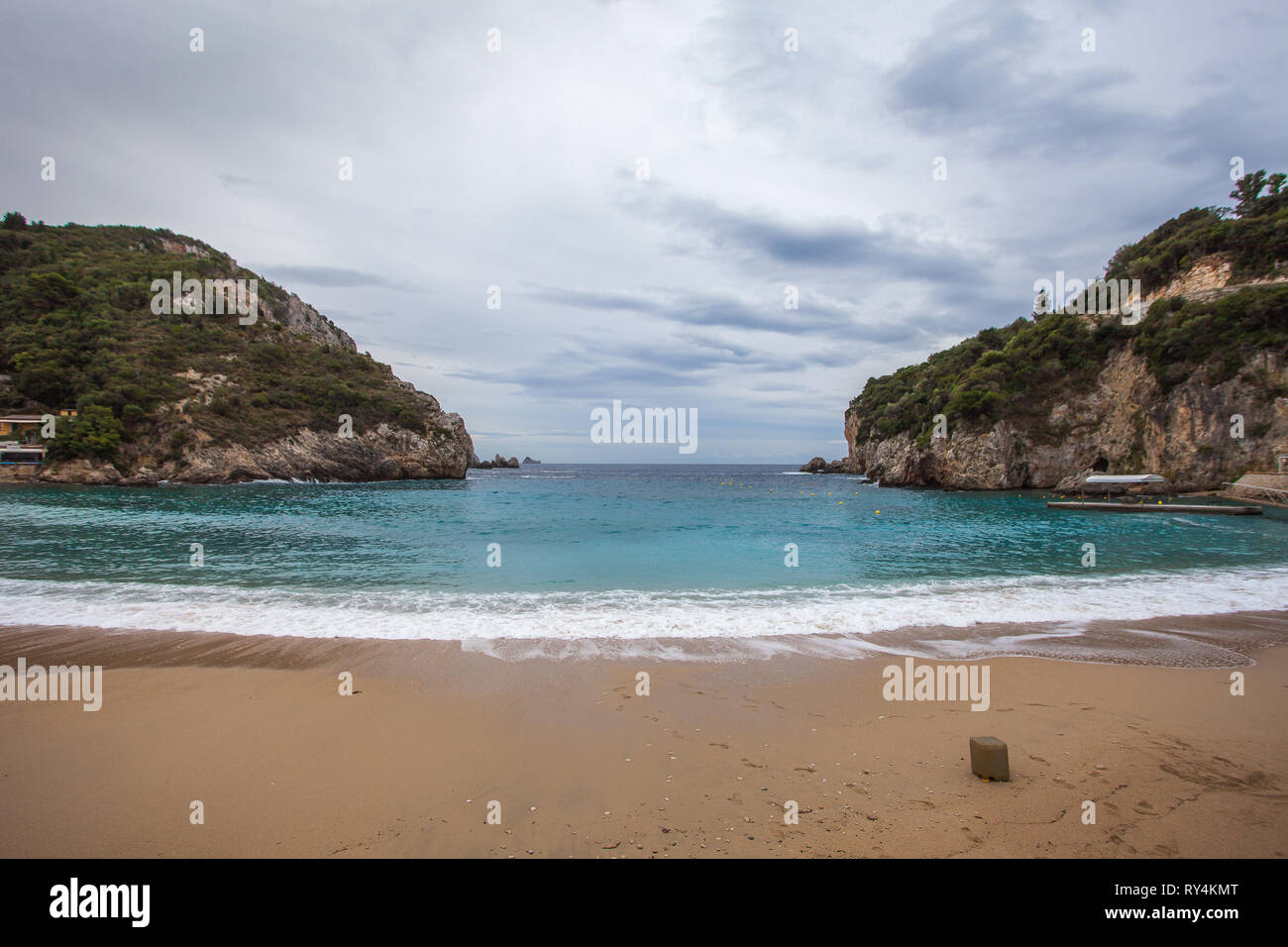 Paleokastritsa bay cliffs and beach with Kolyviri island background on a rainy day, Corfu Island, Greece Stock Photo
