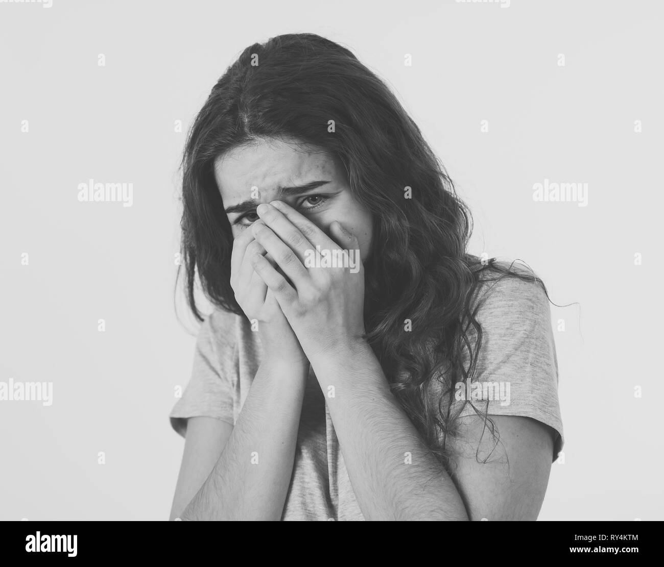 Close up portrait of scared and shocked young teenager female Looking surprised with fear in her eyes. People and Human expressions and emotions conce Stock Photo