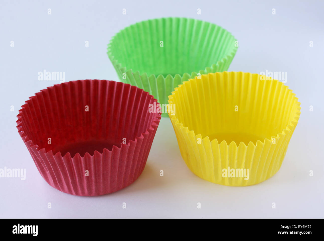 Colorful empty paper forms capsules for muffins and cupcakes on white background - baking dessert - close up on white background Stock Photo