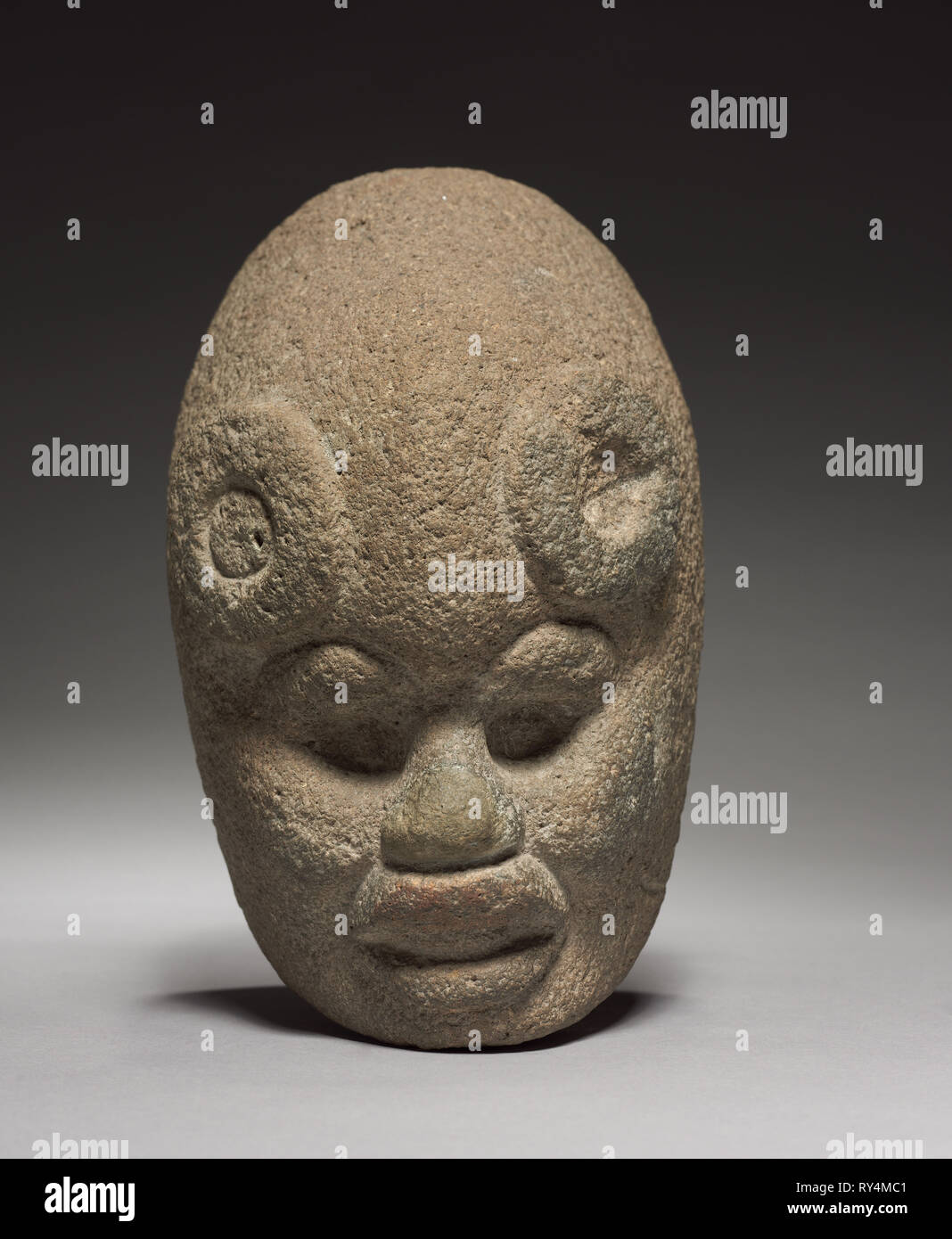 Head, 600-1100. Mexico, Classic Veracruz (Totonac or Tajin). Stone; overall: 25 x 15.8 x 16.5 cm (9 13/16 x 6 1/4 x 6 1/2 in Stock Photo