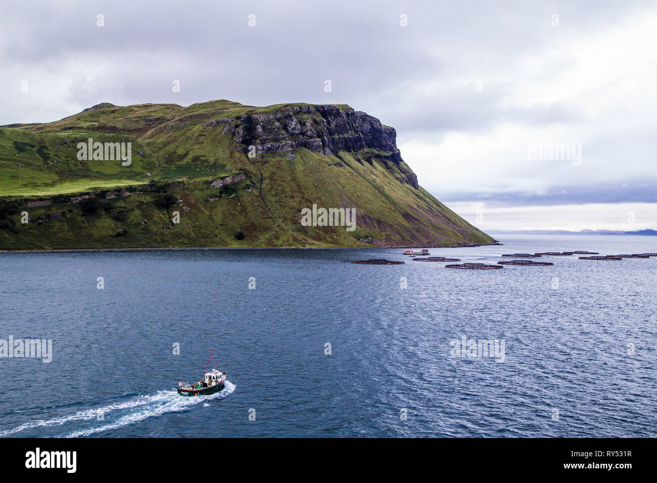 Salmon farm Isle of Skye with fishing boat, Scotland. UK Stock Photo