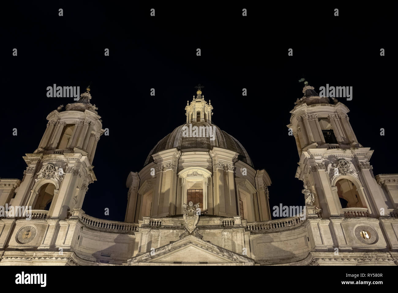 Piazza Navona Square, Borromini's Saint Agnese in Agone church. Front low angle view by night. Rome, Italy, Europe, European Union, EU. Copy space. Stock Photo