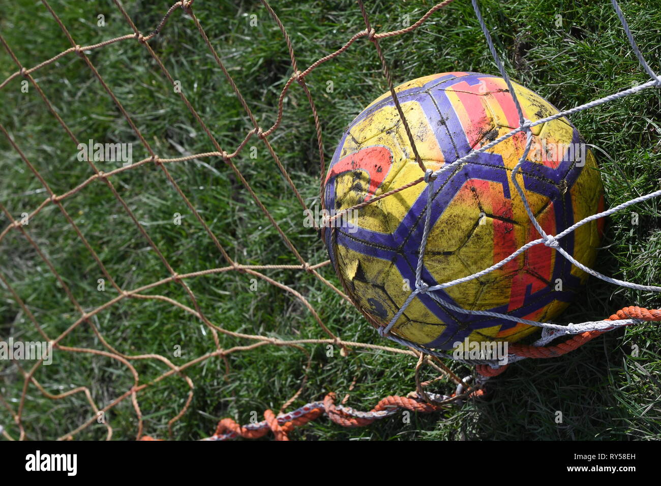 Football in goal nets Stock Photo