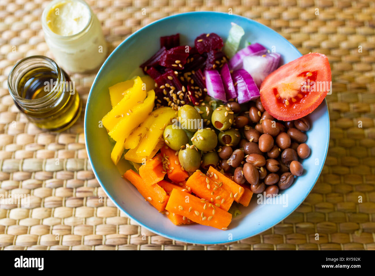 A vibrant vegan buddha bowl filled with colourful vegetables and pulses Stock Photo