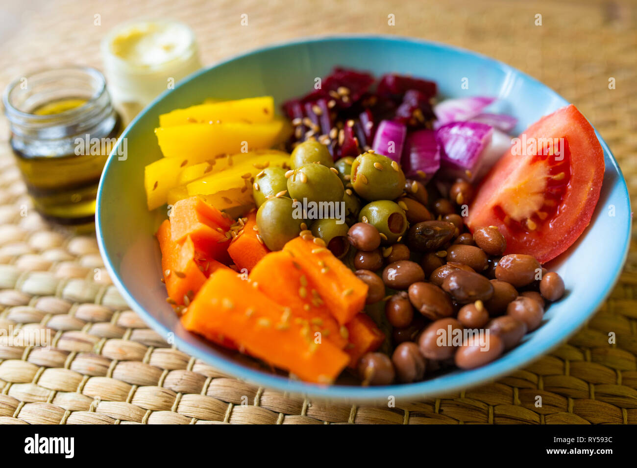 A vibrant vegan buddha bowl filled with colourful vegetables and pulses. Veganism. Veganuary Stock Photo