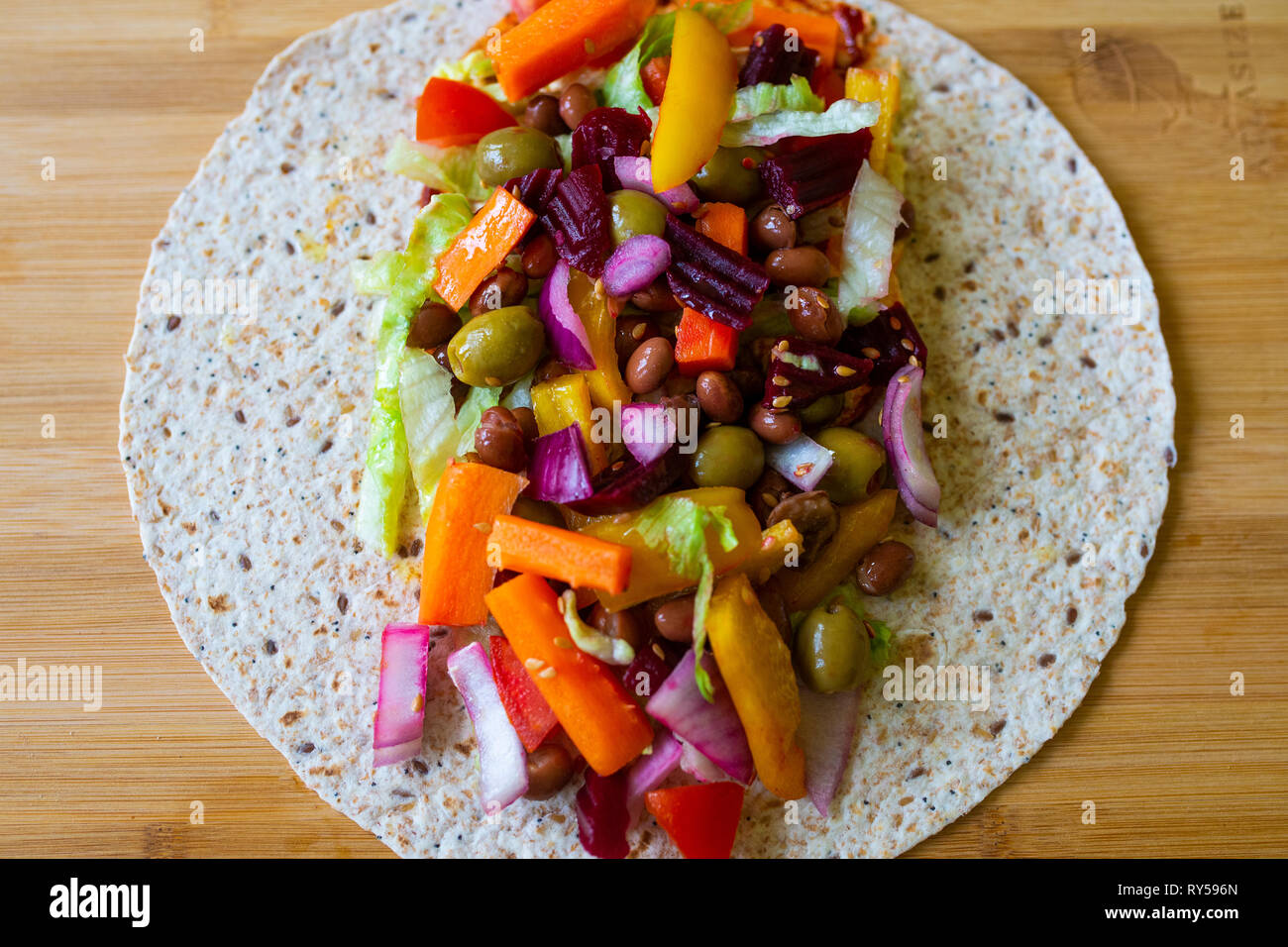 colourful vibrant healthy salad in an open wrap. Vegan. Veganuary Stock Photo