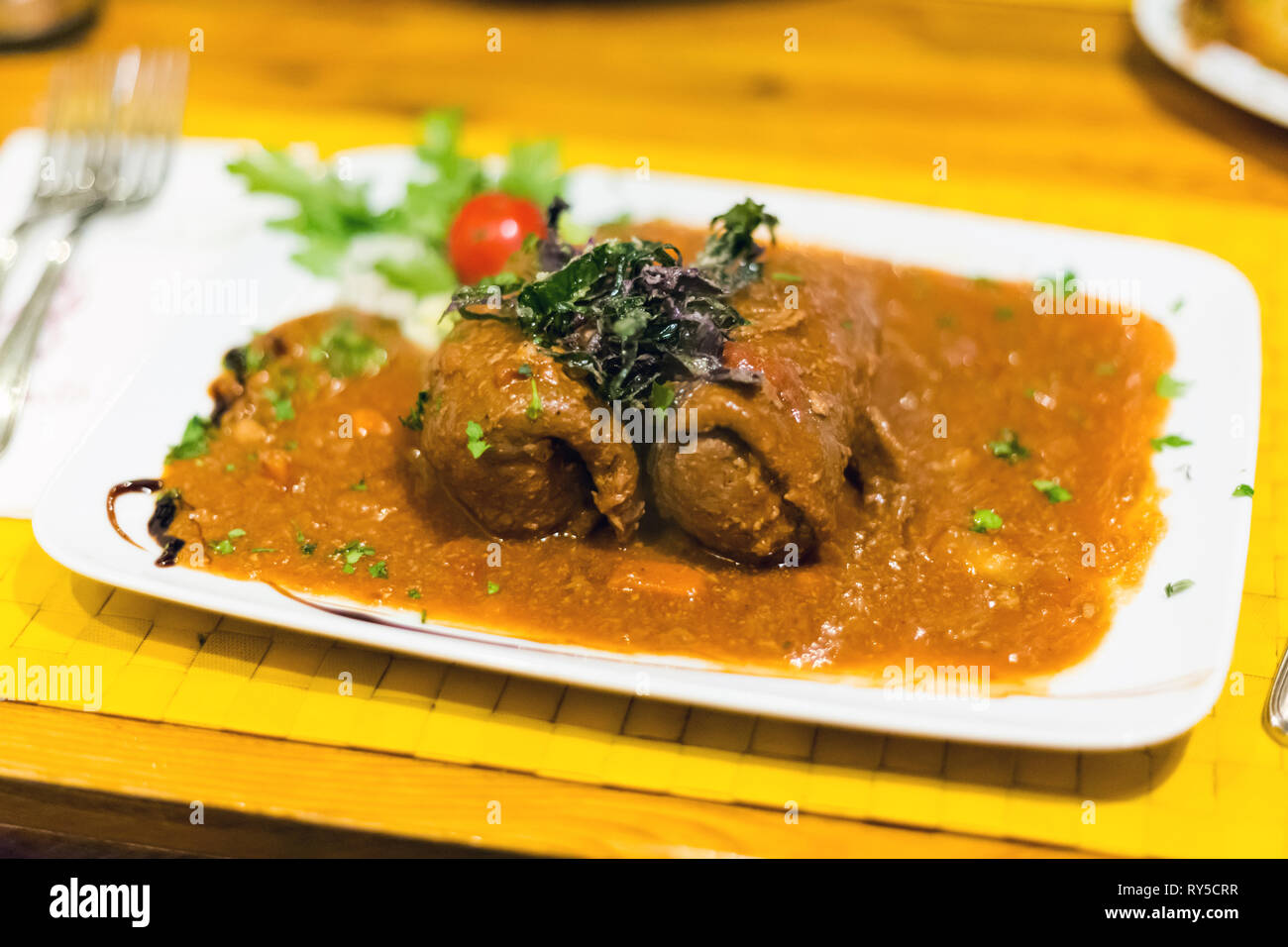 Traditional pork bacon stuffed beef rolls Bragioli served in local