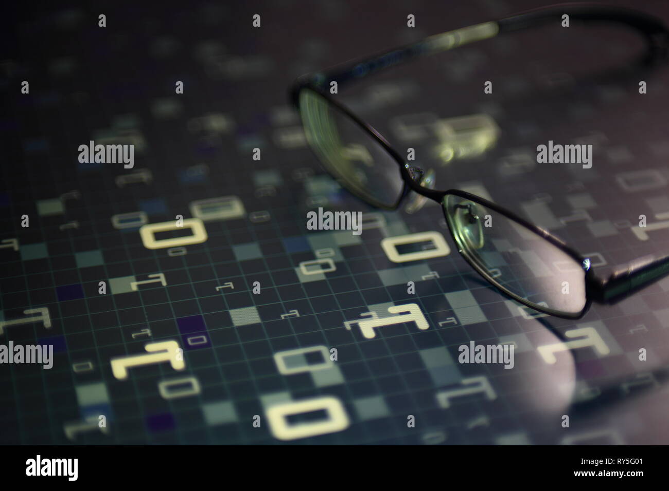 big data analysis. glasses placed on a LED digital panel display white light one and zero binary text number in moving motion pattern. modern technolo Stock Photo