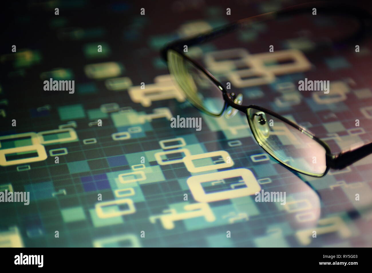 big data analysis. glasses placed on a LED digital panel display white light one and zero binary text number in moving motion pattern. modern technolo Stock Photo