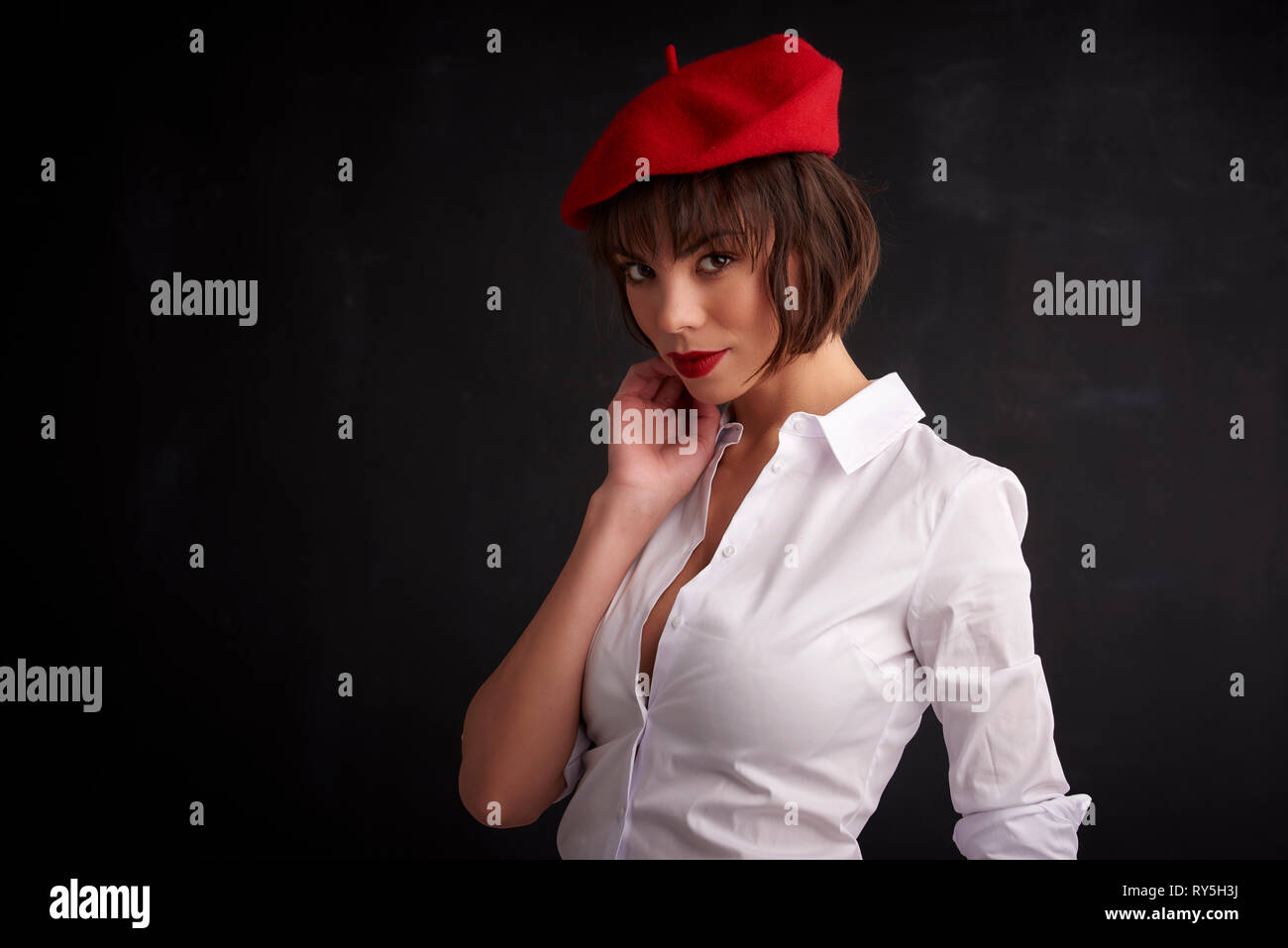 Portrait shot of beautiful young woman wearing red beret and white ...