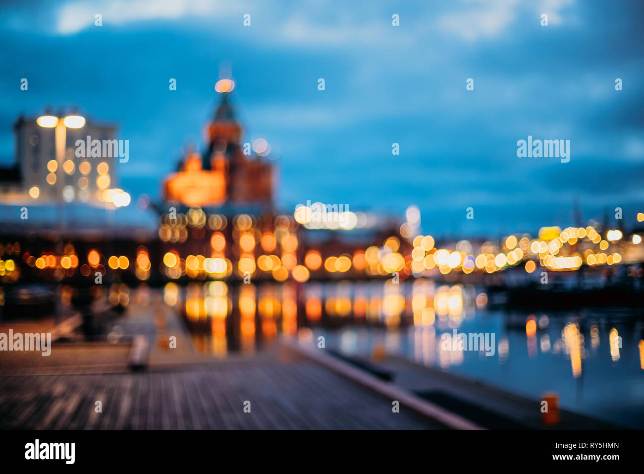 Helsinki, Finland. Abstract Blurred Bokeh Architectural Urban Background Of Uspenski Cathedral And City Embankment. Real Defocused Backdrop Lights Of Stock Photo