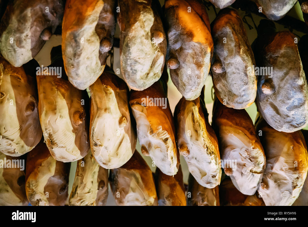 Hanging Italian Drycured Ham Prosciutto In Shop. Italian Cuisine Stock