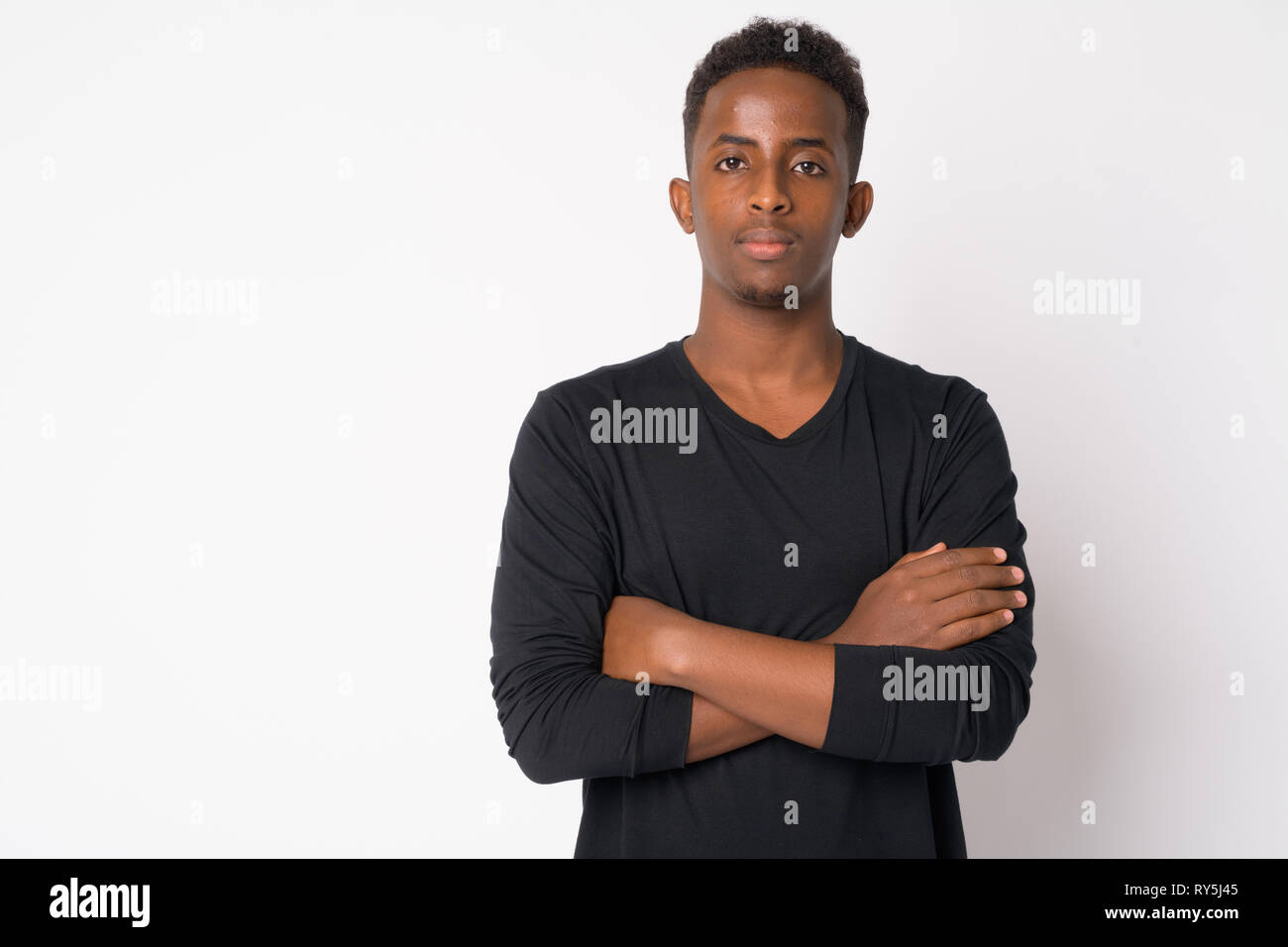 Portrait of young African man with arms crossed Stock Photo - Alamy