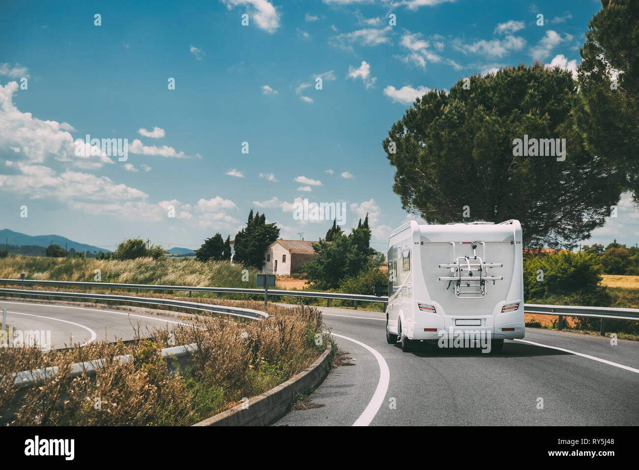 White Caravan Motorhome Car Goes On Highway Road Stock Photo