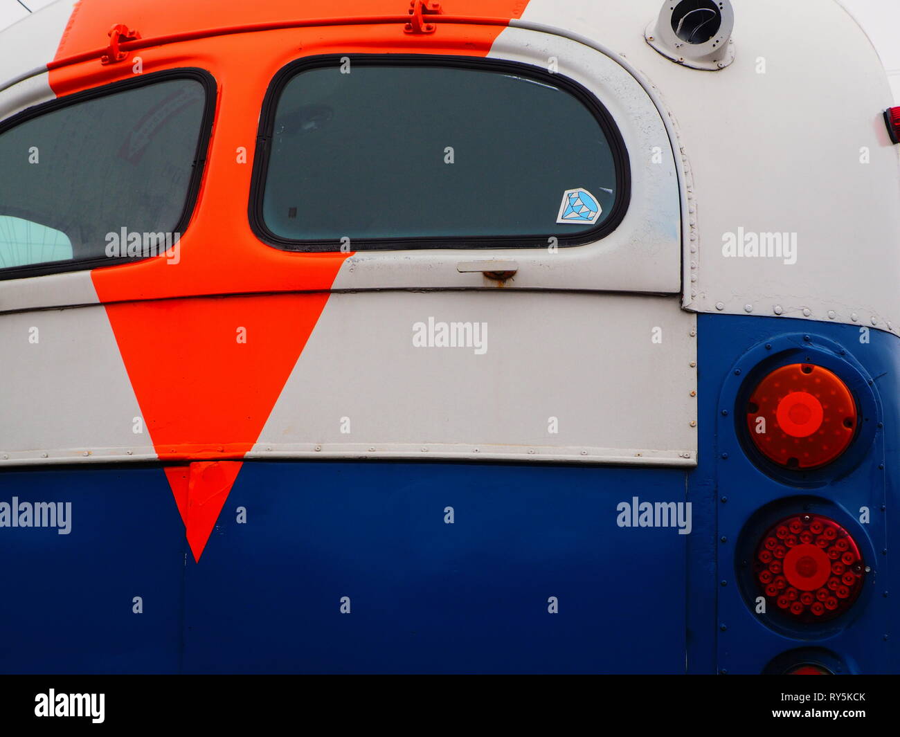 Brightly painted rear of older bus Stock Photo