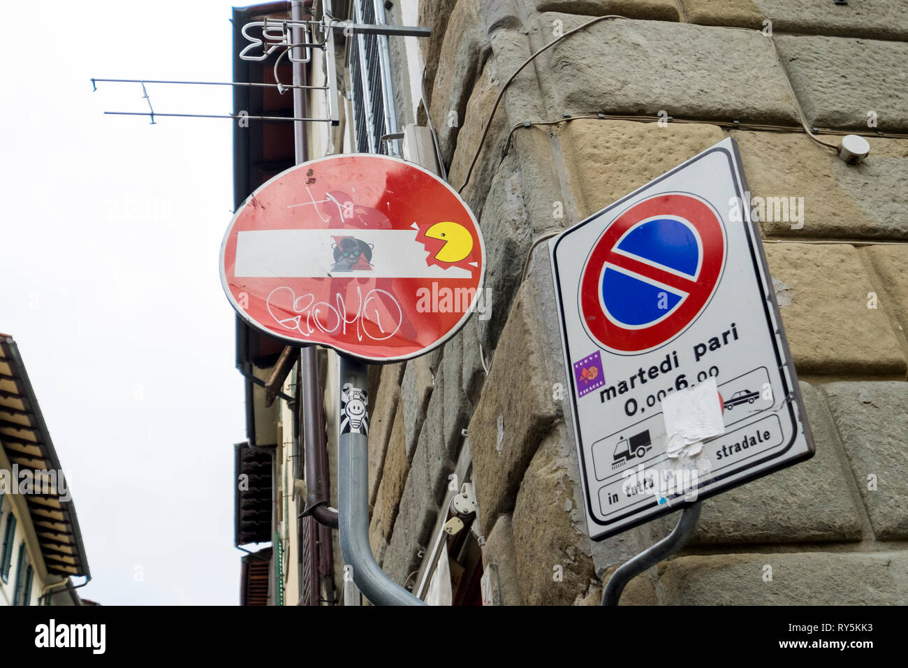 Pac Man is busy easting a Do Not Enter sign, done by artist Clet, in Florence, Italy Stock Photo