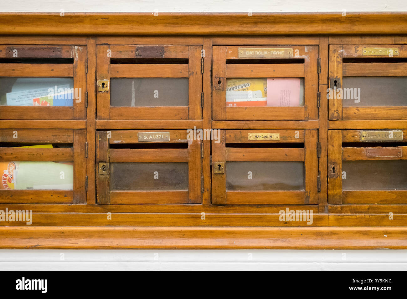 Beautiful old wood mailboxes in an apartment lobby in Florence, Italy Stock Photo