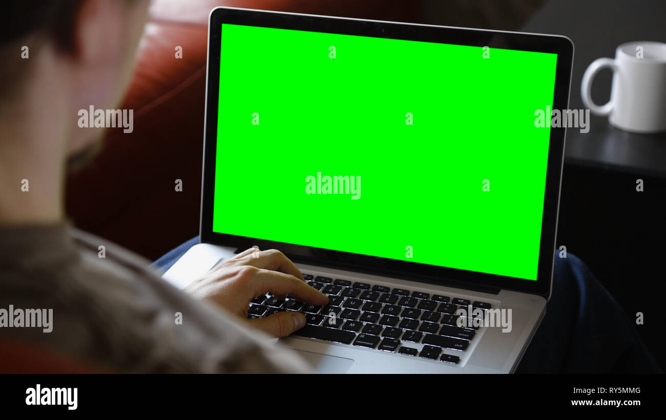 Man Sitting Using Blank Laptop Computer Stock Photo