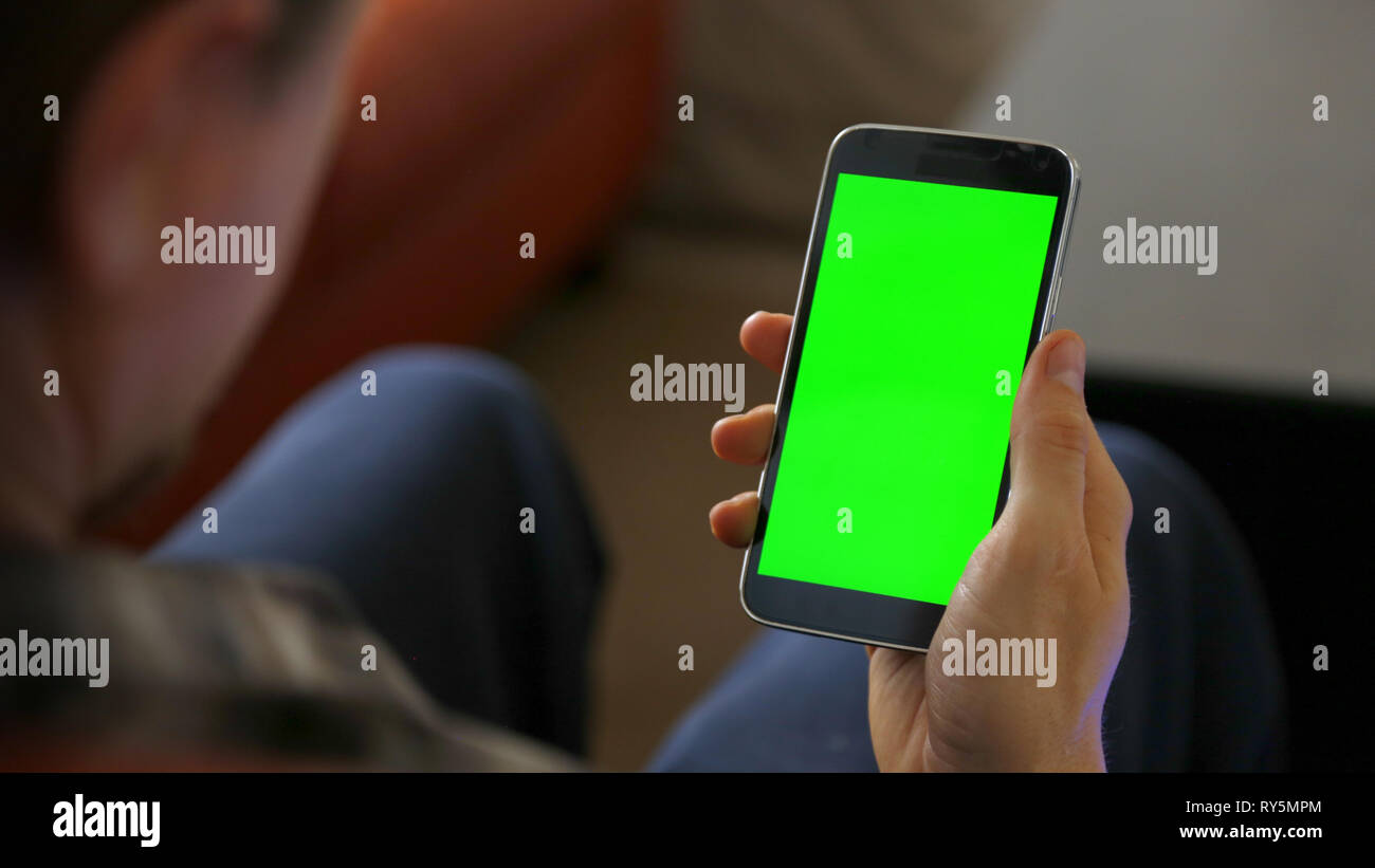 Man Sitting Using Blank Smart Phone Stock Photo