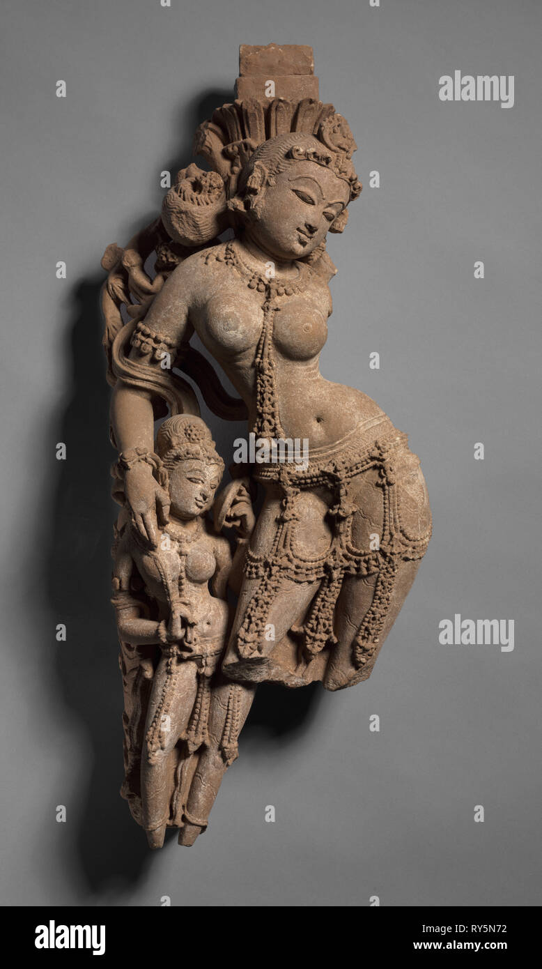Female Tree Deity with Attendant, c. 973. Northwestern India, Rajasthan, Sikar, Harshagiri, 10th century. Sandstone; overall: 54.6 cm (21 1/2 in Stock Photo