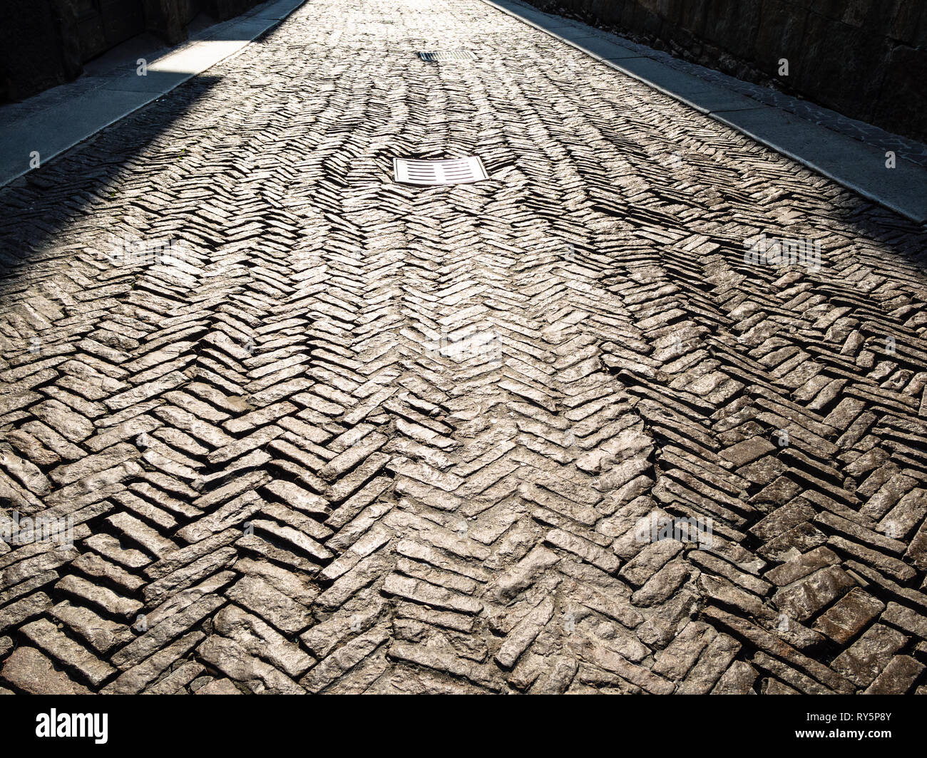 Travel to Italy - stone pavement illuminated by sun of street Via San ...