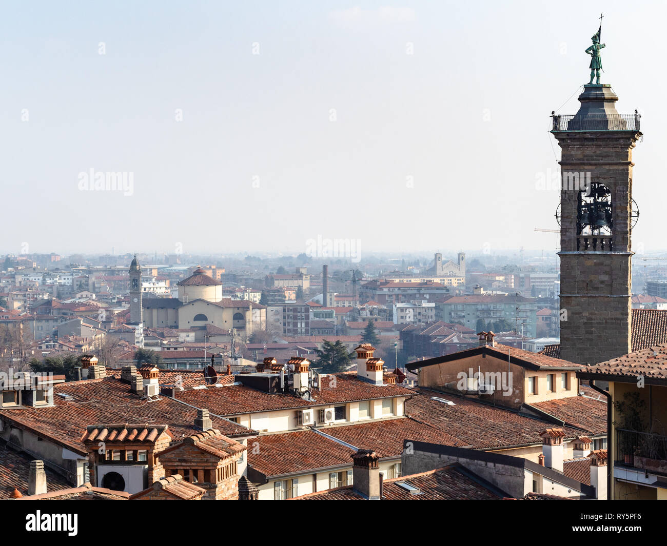 Travel to Italy - above view of Citta Bassa (Lower Town) of Bergamo city with bell tower is spring haze Stock Photo