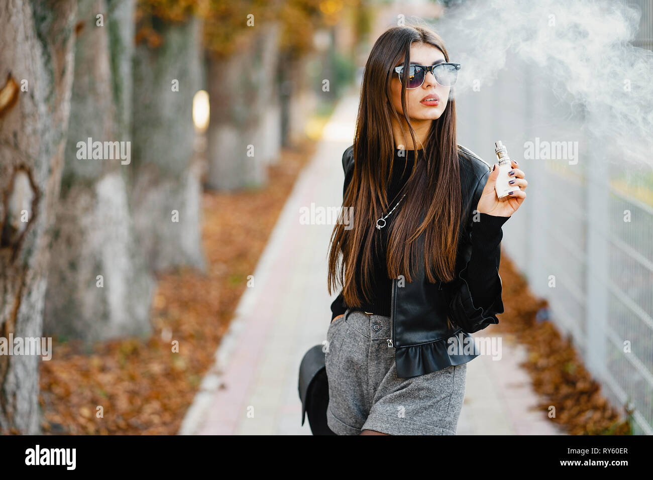 stylish girl smoking an e-cigarette Stock Photo