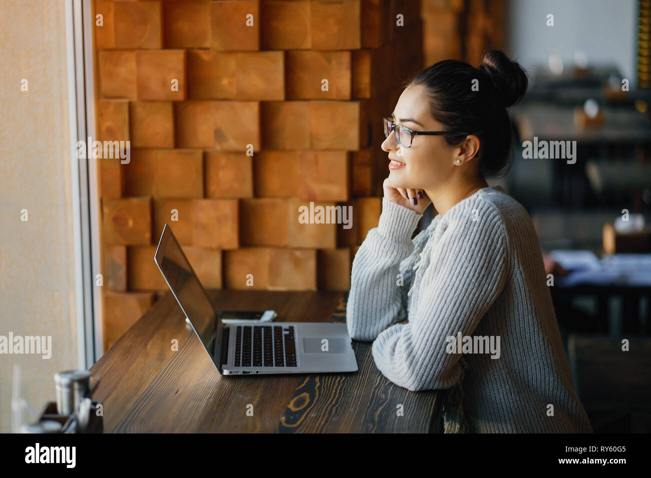 girl working on a laptop at a restaurant Stock Photo