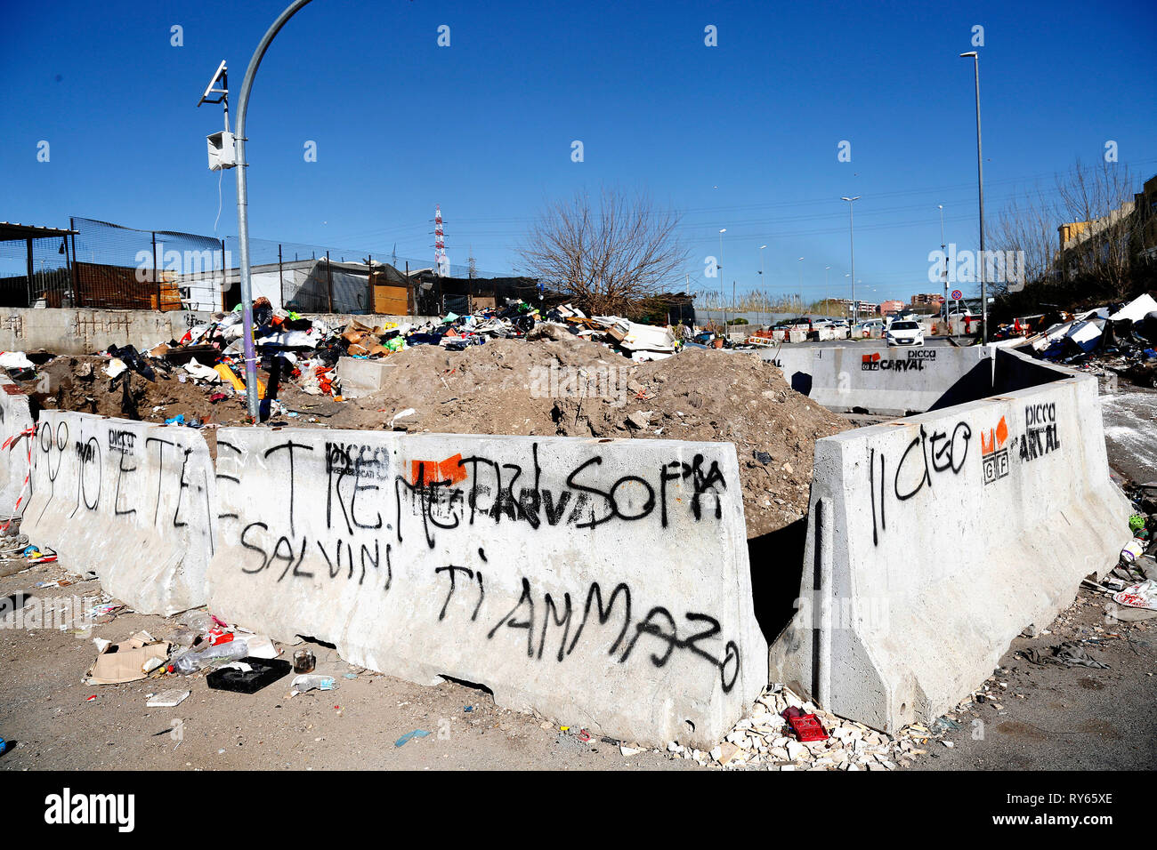 Writing against the Minister of Internal Affairs (Salvini I'll kill you) and the title of the famous film 'Three steps over heaven' Rome March 12th 2019. Salviati Roma camp. After a two years investigation, yesterday morning started the operation 'Tellus' (the name of the Roman God of earth) that led to 15 captures. The illegal activity concerned the disposal and racket of toxic waste. People from the Roma camp Salviati, provided the waste that an illegal company arranged the sale. The surplus was thrown and burned just outside the camp, producing toxic fires that were poisoning the entire dis Stock Photo