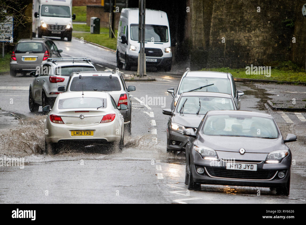 Chippenham, Wiltshire, UK. 12th Mar, 2019. Car drivers are pictured braving heavy rain in Chippenham as heavy rain showers make their way across the UK. Credit: lynchpics/Alamy Live News Stock Photo