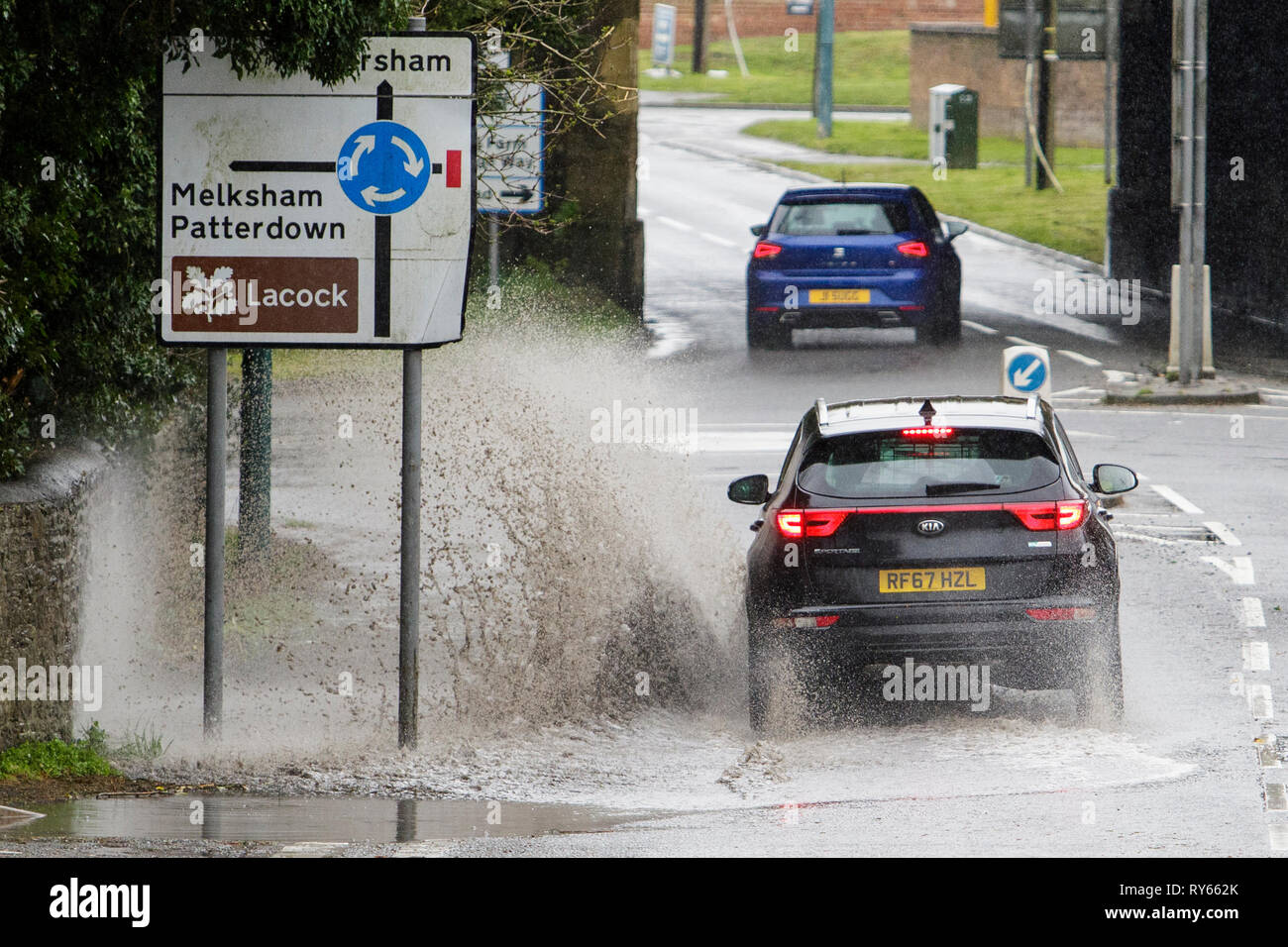 Chippenham, Wiltshire, UK. 12th Mar, 2019. Car drivers are pictured braving heavy rain in Chippenham as heavy rain showers make their way across the UK. Credit: lynchpics/Alamy Live News Stock Photo
