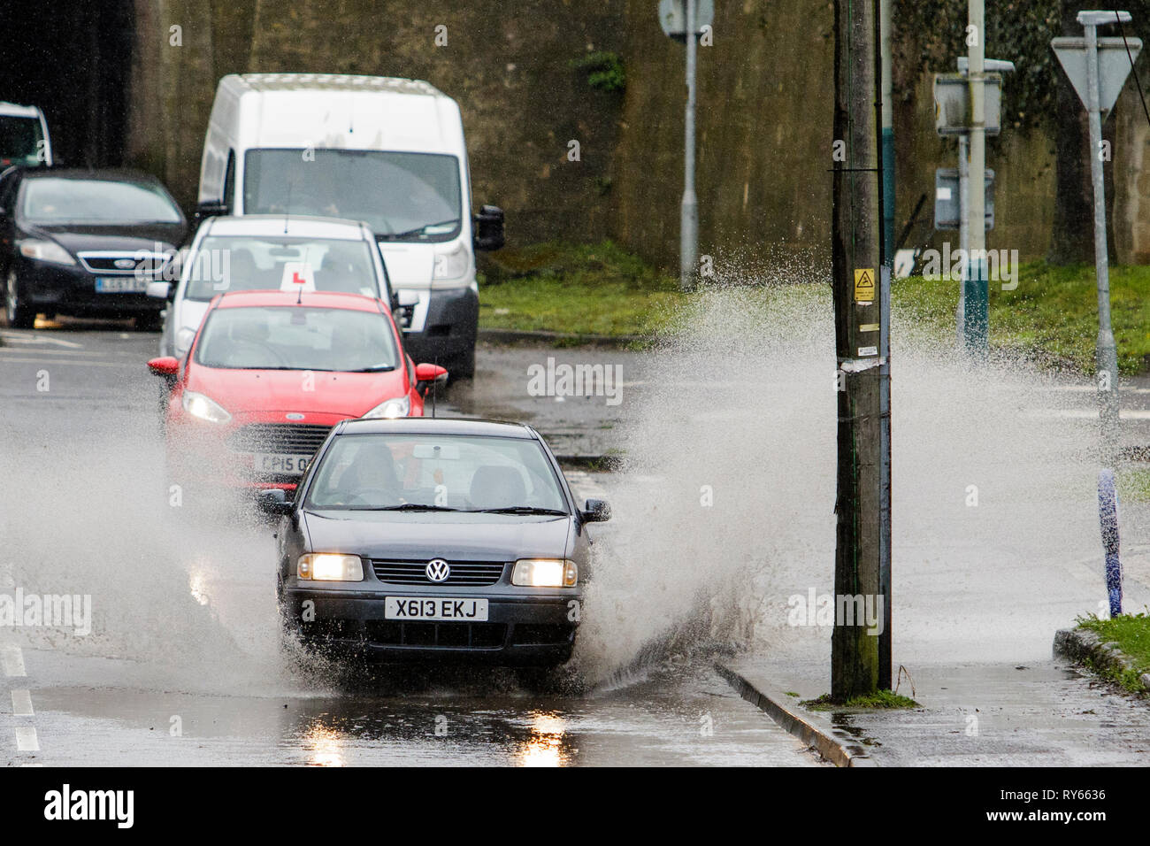 Chippenham, Wiltshire, UK. 12th Mar, 2019. Car drivers are pictured braving heavy rain in Chippenham as heavy rain showers make their way across the UK. Credit: lynchpics/Alamy Live News Stock Photo