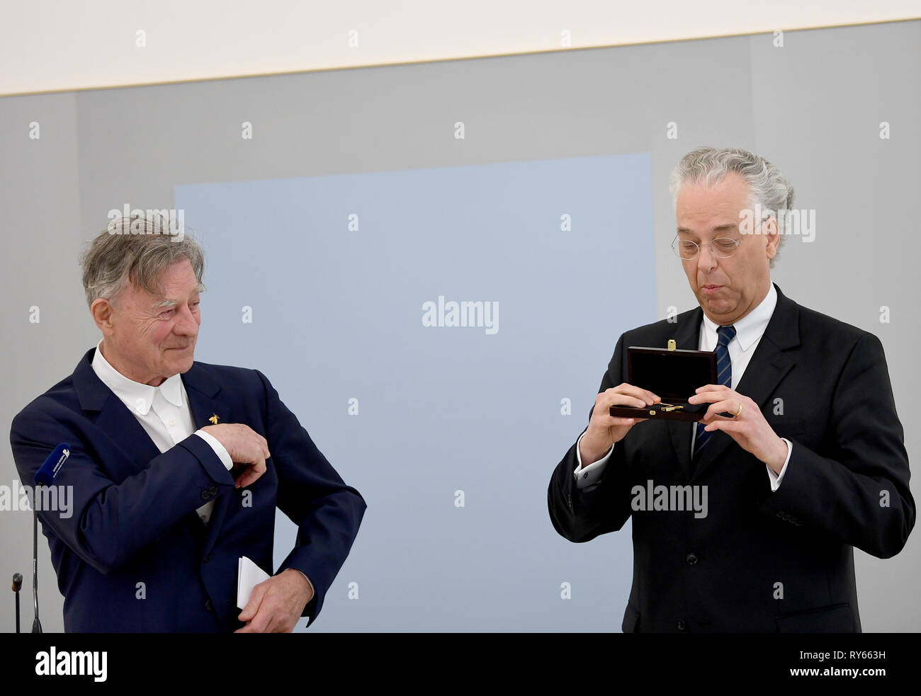 Berlin, Germany. 12th Mar, 2019. Heiner Bastian (l), art collector, presented Michael Eissenhauer, Director General of the Staatliche Museen zu Berlin, with the key to Haus Bastian as a centre for cultural education at the Stiftung Preußischer Kulturbesitz. The building, designed by architect Chipperfield, has been used by the Bastian family as a gallery house since 2007 and was donated to the foundation in 2017. Credit: Britta Pedersen/dpa-Zentralbild/dpa/Alamy Live News Stock Photo