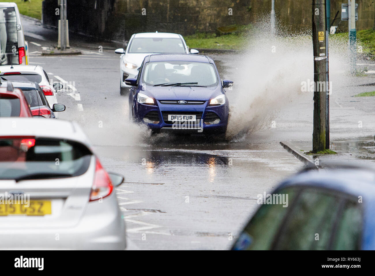 Chippenham, Wiltshire, UK. 12th Mar, 2019. Car drivers are pictured braving heavy rain in Chippenham as heavy rain showers make their way across the UK. Credit: lynchpics/Alamy Live News Stock Photo