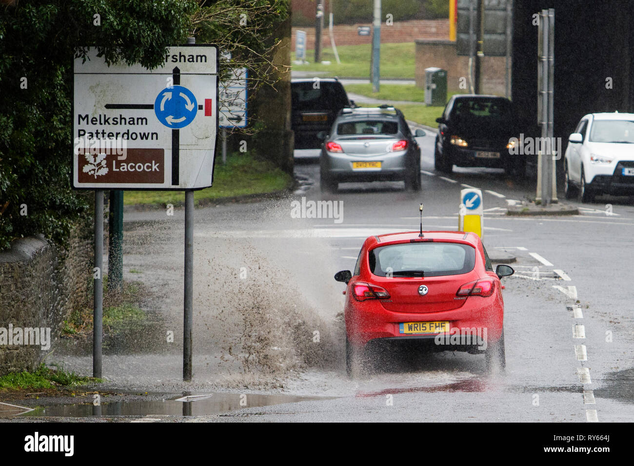 Chippenham, Wiltshire, UK. 12th Mar, 2019. Car drivers are pictured braving heavy rain in Chippenham as heavy rain showers make their way across the UK. Credit: lynchpics/Alamy Live News Stock Photo
