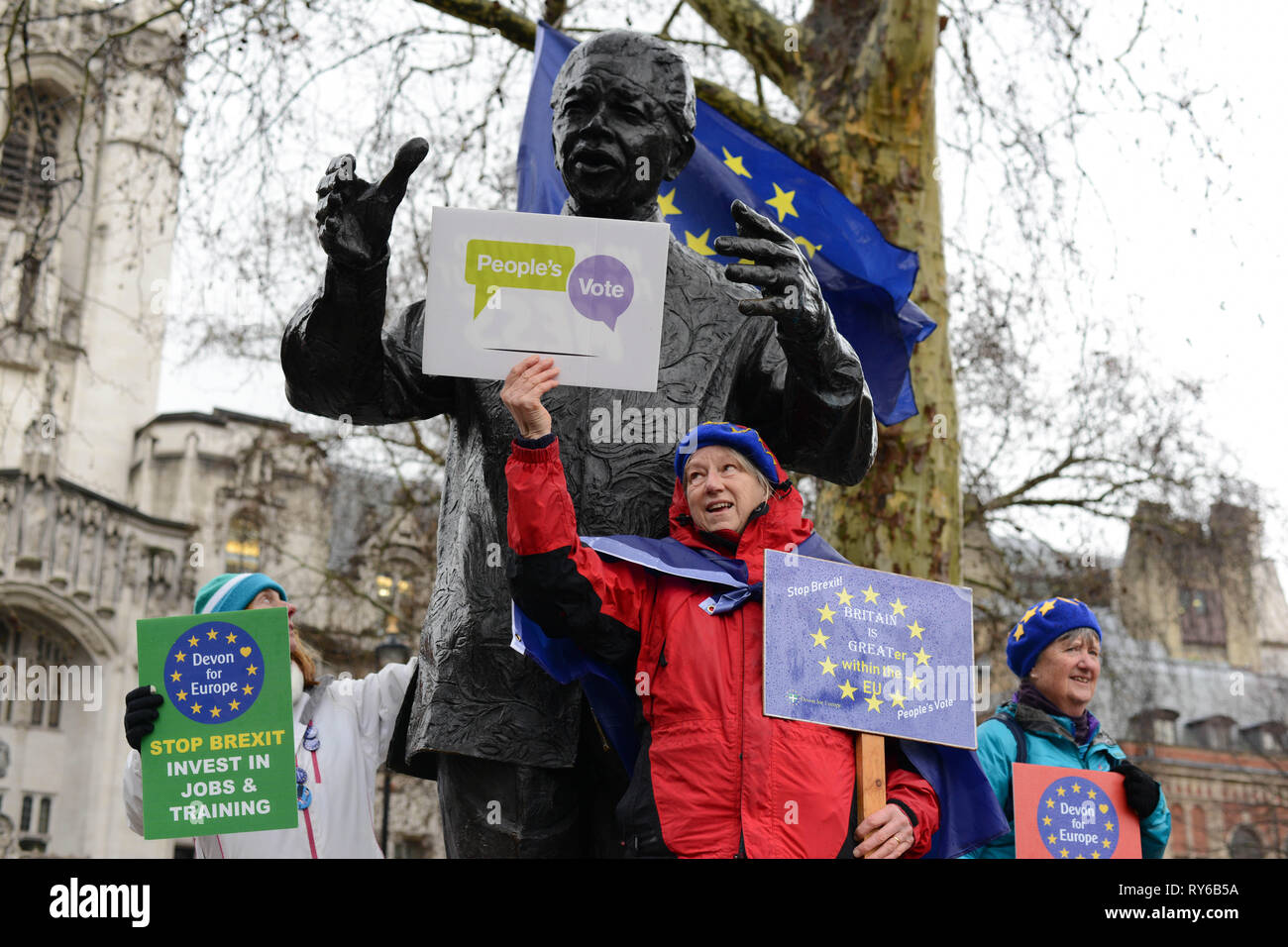 London, UK. 12th March, 2019. Anti-Brexit  Activists demonstrate next to Nelson Mandela Statue in Parliament Square Opposite The Houses Of Parliament. Westminster, London. 12th of March 2019. Credit: Thomas Krych/Alamy Live News Stock Photo