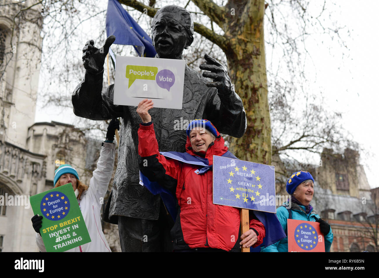 London, UK. 12th March, 2019. Anti-Brexit  Activists demonstrate next to Nelson Mandela Statue in Parliament Square Opposite The Houses Of Parliament. Westminster, London. 12th of March 2019. Credit: Thomas Krych/Alamy Live News Stock Photo