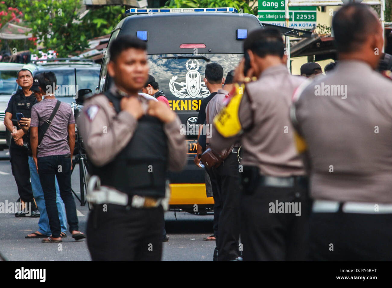 Sibolga, North Sumatra, Indonesia. 12th Mar, 2019. Indonesian police  officers in front of the site where an explosive device went off during a  terror raid in North Sumatra. The bomb wounded an
