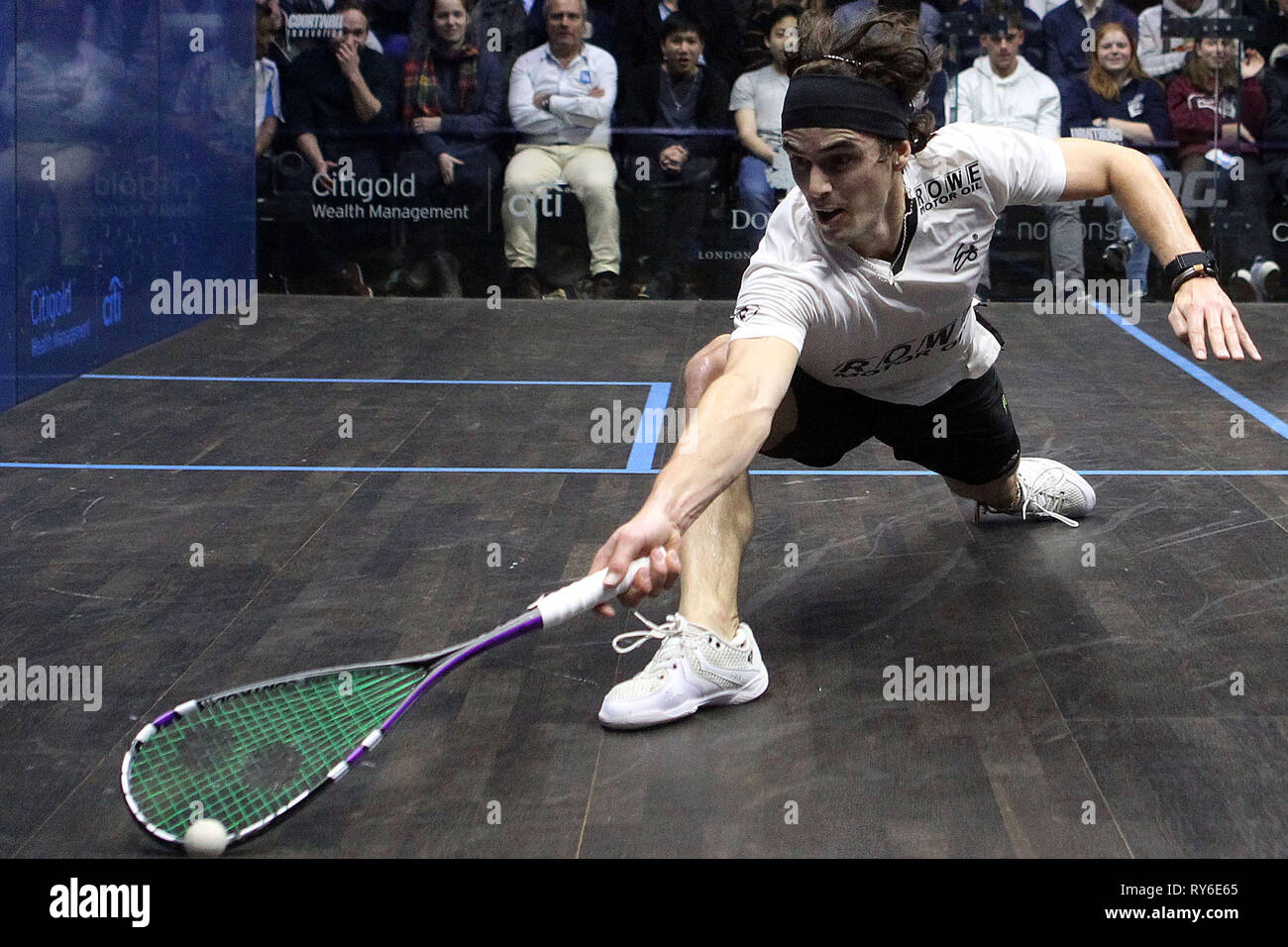 London, UK. 12th Mar, 2019. Paul Coll of New Zealand in action against Tom Richards of England. Citigold Canary Wharf Squash Classic, day 3, round 2 at the East Wintergarden in Canary Wharf , London on Tuesday 12th March 2019.   pic by  Steffan Bowen/Andrew Orchard sports photography/Alamy Live news Stock Photo