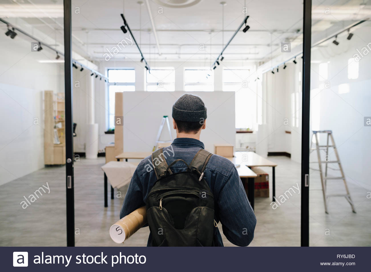 Male artist arriving at art gallery Stock Photo