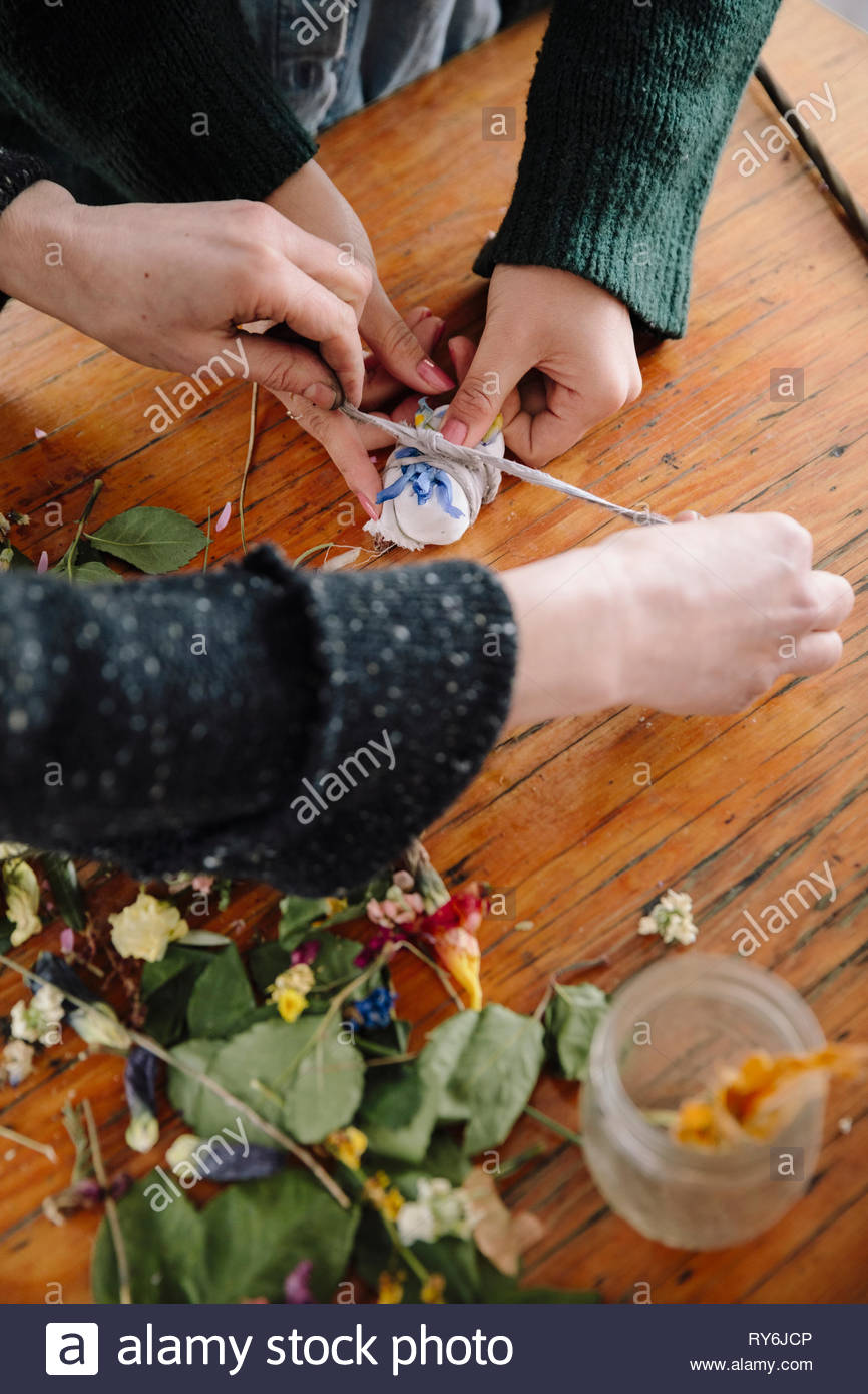 Artists tying dried flowers Stock Photo Alamy
