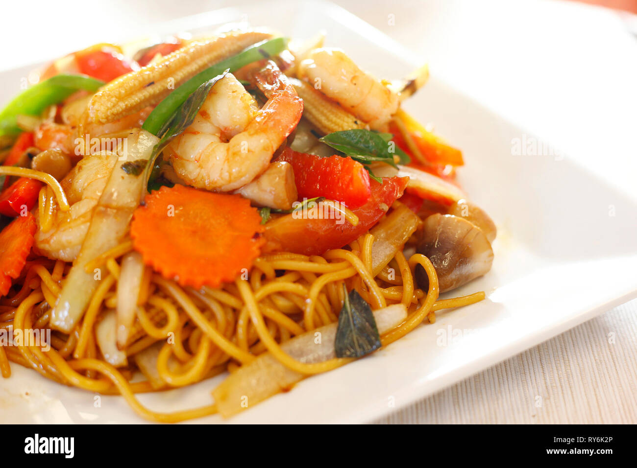 Close-up of noodles with vegetables and prawns served in plate on table Stock Photo